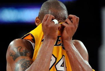 LOS ANGELES, CA - MAY 21:  Kobe Bryant #24 of the Los Angeles Lakers wipes his face in the second quarter against the Denver Nuggets in Game Two of the Western Conference Finals during the 2009 NBA Playoffs at Staples Center on May 21, 2009 in Los Angeles, California. NOTE TO USER: User expressly acknowledges and agrees that, by downloading and or using this photograph, User is consenting to the terms and conditions of the Getty Images License Agreement.  (Photo by Kevork Djansezian/Getty Images)
