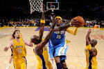 LOS ANGELES, CA - MAY 21:  Carmelo Anthony #15 of the Denver Nuggets goes for a shot between Lamar Odom #7 and Kobe Bryant #24 of the Los Angeles Lakers in the first half in Game Two of the Western Conference Finals during the 2009 NBA Playoffs at Staples Center on May 21, 2009 in Los Angeles, California. NOTE TO USER: User expressly acknowledges and agrees that, by downloading and or using this photograph, User is consenting to the terms and conditions of the Getty Images License Agreement.  (Photo by Kevork Djansezian/Getty Images)