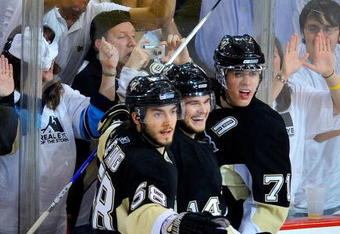 PITTSBURGH - MAY 21:  Chris Kunitz #14 of the Pittsburgh Penguins celebrates his goal against the Carolina Hurricanes with Kris Letang #58 and Evgeni Malkin #71 during Game Two of the Eastern Conference Championship Round of the 2009 Stanley Cup Playoffs at Mellon Arena on May 21, 2009 in Pittsburgh, Pennsylvania.  (Photo by Jamie Sabau/Getty Images)