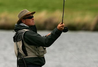CHRISTCHURCH, NEW ZEALAND - FEBRUARY 24: An angler fishes for trout in the lake during Day 3 of the New Zealand PGA Championship at Clearwater February 24, 2007 in Christchurch, New Zealand.  (Photo by Phil Walter/Getty Images)