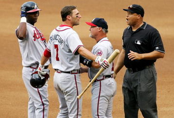 NEW YORK - SEPTEMBER 06:  First base coach Glenn Hubbard of the Atlanta Braves gets between Jeff Francoeur #7 and umpire Kerwin Danley as Francoeur argues after being called out on fan interference against the New York Mets as Edgar Renteria #11 looks on on September 6, 2006 during the second game of their doubleheader at Shea Stadium in the Flushing neighborhood of the Queens borough of New York City.   (Photo by Jim McIsaac/Getty Images)