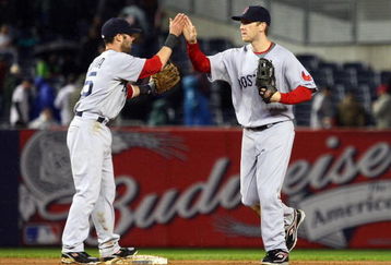 NEW YORK - MAY 05:  Dustin Pedroia #15 and Jason Bay #44 of the Boston Red Sox celebrate after the final out of the game against the New York Yankees on May 5, 2009 at Yankee Stadium in the Bronx borough of New York City. The Red Sox defeated the Yankees 7-3.  (Photo by Jim McIsaac/Getty Images)