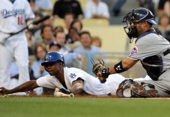 LOS ANGELES, CA - MAY 18:  Juan Pierre #9 of the Los Angeles Dodgers slides in ahead of the tag of Ramon Castro #11 of the New York Mets to score a run for a 1-0 lead during the first inning at Dodger Stadium on May 18, 2009 in Los Angeles, California.  (Photo by Harry How/Getty Images)