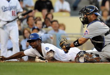 LOS ANGELES, CA - MAY 18:  Juan Pierre #9 of the Los Angeles Dodgers slides in ahead of the tag of Ramon Castro #11 of the New York Mets to score a run for a 1-0 lead during the first inning at Dodger Stadium on May 18, 2009 in Los Angeles, California.  (Photo by Harry How/Getty Images)
