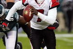 PHILADELPHIA - DECEMBER 31:  Michael Vick #7 of the Atlanta Falcons looks to pass against the Philadelphia Eagles in NFL action December 31, 2006 at Lincoln Financial Field in Philadelphia, Pennsylvania. The Eagles won 24-17.  (Photo by Jim McIsaac/Getty Images)