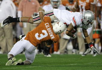 GLENDALE, AZ - JANUARY 05:  Wide reciever DeVier Posey #8 of the Ohio State Buckeyes leaps for a first down over Curtis Brown #3 of the Texas Longhorns during the Tostitos Fiesta Bowl Game on January 5, 2009 at University of Phoenix Stadium in Glendale, Arizona.  (Photo by Doug Pensinger/Getty Images)