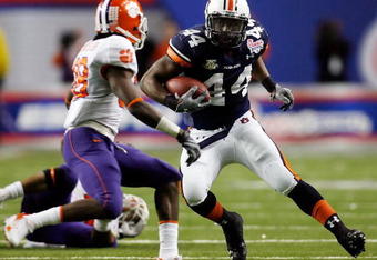 ATLANTA - DECEMBER 31:  Ben Tate #44 of the Auburn University Tigers runs against Chris Chancellor #38 of the Clemson University Tigers during the Chick-Fil-A Bowl on December 31, 2007 at the Georgia Dome in Atlanta, Georgia.  (Photo by Chris Graythen/Getty Images)