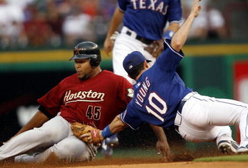 ARLINGTON, TX - JUNE 24:  Carlos Lee #45 of the Houston Astros is tagged out by Michael Young #10 of the Texas Rangers at the Rangers Ballpark June 24, 2007 in Arlington, Texas.  (Photo by Layne Murdoch/Getty Images)