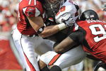 TAMPA, FL - SEPTEMBER 14: Defensive tackle Jonathan Babineaux #95 and defensive end Kroy Biermann #71 of the Atlanta Falcons stop running back Warrick Dunn #28 of the Tampa Bay Buccaneers at Raymond James Stadium on September 14, 2008 in Tampa, Florida.  (Photo by Al Messerschmidt/Getty Images)