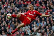 LIVERPOOL, UNITED KINGDOM - OCTOBER 18: Liverpool striker Dirk Kuyt scores the third Liverpool goal during the Barclays Premier League match between Liverpool and Wigan Athletic at Anfield on October 18, 2008 in Liverpool, England.  (Photo by Stu Forster/Getty Images)