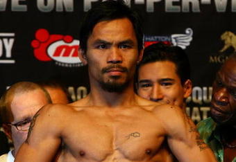 LAS VEGAS - MAY 01:  Manny Pacquiao of the Philippines steps on the scale at 138 pounds during the weigh-in for his junior welterweight title fight against Ricky Hatton of England at the MGM Grand Garden Arena May 1, 2009 in Las Vegas, Nevada.  (Photo by Al Bello/Getty Images)