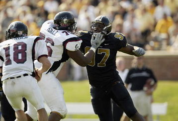 COLUMBIA, MO - SEPTEMBER 28:  Defensive lineman Atiyyah Ellison #97 of the Missouri Tigers battles past offensive lineman Branden Hall #76 of the Troy State Trojans to get to quarterback Hansell Bearden #18 during the NCAA football game on September 28, 2002 at Faurot Field in Columbia, Missouri.  Missouri won 44-7. (Photo by Brian Bahr/Getty Images)