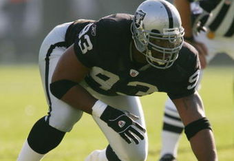 OAKLAND - DECEMBER 19:  Tommy Kelly #93 of the Oakland Raiders gets into position before the snap during the game against the Tennessee Titans on December 19, 2004 at Network Associates Colesium in Oakland, California.  (Photo by Lisa Blumenfeld/Getty Images)