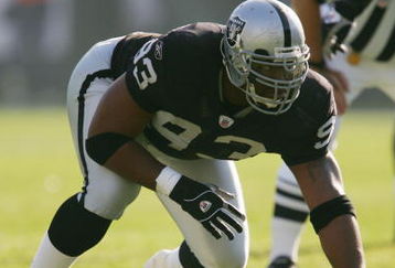OAKLAND - DECEMBER 19:  Tommy Kelly #93 of the Oakland Raiders gets into position before the snap during the game against the Tennessee Titans on December 19, 2004 at Network Associates Colesium in Oakland, California.  (Photo by Lisa Blumenfeld/Getty Images)