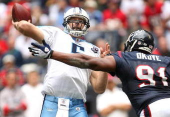 HOUSTON - DECEMBER 14:  Quarterback Kerry Collins #5 of the Tennessee Titans throws a pass over defensive tackle Amobi Okoye #91 of the Houston Texans on December 14, 2008 at Reliant Stadium in Houston, Texas.  (Photo by Stephen Dunn/Getty Images)
