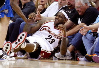 CLEVELAND - MAY 22:  LeBron James #23 of the Cleveland Cavaliers falls near the crowd on the sidelines during Game Two of the Eastern Conference Finals against the Orlando Magic during the 2009 Playoffs at Quicken Loans Arena on May 22, 2009 in Cleveland, Ohio. NOTE TO USER: User expressly acknowledges and agrees that, by downloading and or using this photograph, User is consenting to the terms and conditions of the Getty Images License Agreement  (Photo by Gregory Shamus/Getty Images)