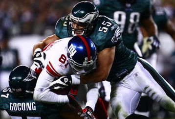 PHILADELPHIA - NOVEMBER 09:  Amani Toomer #81 of the New York Giants is tackled by Stewart Bradley #55 and Chris Gocong #57 of the Philadelphia Eagles at Lincoln Financial Field on November 9, 2008 in Philadelphia, Pennsylvania.  (Photo by Chris McGrath/Getty Images)