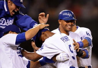 LOS ANGELES, CA - MAY 23:  Juan Pierre #9 (C) of the Los Angeles Dodgers is congratulated by pitcher Clayton Kershaw (L) catcher Russell Martin (2L) and Matt Kemp #27 who scored the winning run after a bases loaded walk to Pierre to defeat the Los Angeles Angels of Anaheim, 5-4, during the tenth inning of the baseball game at Dodger Stadium on May 23, 2009 in Los Angeles, California.  (Photo by Kevork Djansezian/Getty Images)