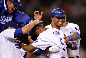 LOS ANGELES, CA - MAY 23:  Juan Pierre #9 (C) of the Los Angeles Dodgers is congratulated by pitcher Clayton Kershaw (L) catcher Russell Martin (2L) and Matt Kemp #27 who scored the winning run after a bases loaded walk to Pierre to defeat the Los Angeles Angels of Anaheim, 5-4, during the tenth inning of the baseball game at Dodger Stadium on May 23, 2009 in Los Angeles, California.  (Photo by Kevork Djansezian/Getty Images)