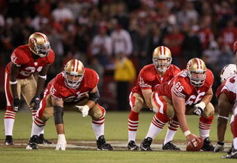 SAN FRANCISCO - SEPTEMBER 10:  Frank Gore #21, Justin Smiley #65 and Eric Heitmann #66 wait for Alex Smith #11 of the San Francisco 49ers to receive the ball during an NFL game against the Arizona Cardinals on September 10, 2007 at Monster Park in San Francisco, California.  The 49ers won 20-17.  (Photo by Jed Jacobsohn/Getty Images)