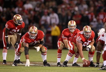 SAN FRANCISCO - SEPTEMBER 10:  Frank Gore #21, Justin Smiley #65 and Eric Heitmann #66 wait for Alex Smith #11 of the San Francisco 49ers to receive the ball during an NFL game against the Arizona Cardinals on September 10, 2007 at Monster Park in San Francisco, California.  The 49ers won 20-17.  (Photo by Jed Jacobsohn/Getty Images)