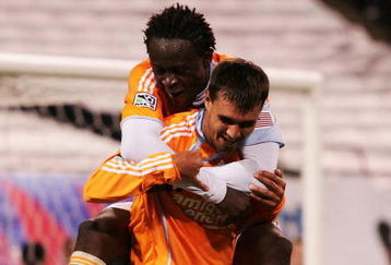 EAST RUTHERFORD, NJ - MAY 16:  Chris Wondolowski #7 of the Houston Dynamo celebrates his goal in the 78th minute with teammate Kei Kamara #10 against the New York Red Bulls at Giants Stadium in the Meadowlands on May 16, 2009 in East Rutherford, New Jersey.  (Photo by Mike Stobe/Getty Images for New York Red Bull)