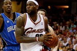 CLEVELAND - MAY 22:  LeBron James #23 of the Cleveland Cavaliers drives to the hoop against Dwight Howard #12 of the Orlando Magic in Game Two of the Eastern Conference Finals during the 2009 Playoffs at Quicken Loans Arena on May 22, 2009 in Cleveland, Ohio. NOTE TO USER: User expressly acknowledges and agrees that, by downloading and or using this photograph, User is consenting to the terms and conditions of the Getty Images License Agreement  (Photo by Gregory Shamus/Getty Images)
