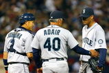 MINNEAPOLIS, MN - APRIL 6: Pitching coach Mike Adair #40 of the Seattle Mariners talks with Felix Hernandez #34 and Kenji Johjima #2 of the Seattle Mariners during a game against the Minnesota Twins at the Metrodome on April 6, 2009 in Minneapolis, Minnesota. (Photo by Scott A. Schneider/Getty Images)