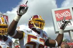 TAMPA, FL - NOVEMBER 25: Linebacker Rocky McIntosh #52 and defensive tackle Kedric Golston #64 of the Washington Redskins run  to the field before play against the Tampa Bay Buccaneers at the Raymond James Stadium on November 25, 2007 in Tampa, Florida.  The Bucs won 19-13. (Photo by Al Messerschmidt/Getty Images)