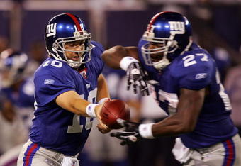 EAST RUTHERFORD, NJ - AUGUST 18:  Eli Manning #10 of the New York Giants hands the ball to teammate Brandon Jacobs #27 against the Cleveland Browns on August 18, 2008 at Giants Stadium in East Rutherford, New Jersey.  (Photo by Jim McIsaac/Getty Images)