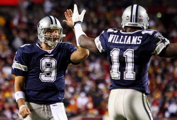 LANDOVER, MD - NOVEMBER 16:  Tony Romo #9 of the Dallas Cowboys celebrates his teams first touchdown against the Washington Redskins with teammate Roy Williams #11 on November 16, 2008 at FedEx Field in Landover, Maryland.  (Photo by Jim McIsaac/Getty Images)