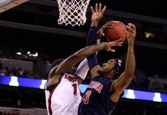 INDIANAPOLIS - MARCH 27:  Jordan Hill #43 of the Arizona Wildcats fights for a rebound against Terrence Williams #1 of the Louisville Cardinals  during the third round of the NCAA Division I Men's Basketball Tournament at the Lucas Oil Stadium on March 27, 2009 in Indianapolis, Indiana.  (Photo by Andy Lyons/Getty Images)