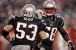 FOXBOROUGH, MA - AUGUST 17:  Pierre Woods #58 of the New England Patriots celebrates with teammate Larry Izzo #53 after Izzo made the stop against the Tennessee Titans during the first half of a pre-season game at Gillette Stadium August 17, 2007 in Foxborough, Massachusetts.  (Photo by Elsa/Getty Images)