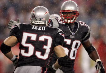 FOXBOROUGH, MA - AUGUST 17:  Pierre Woods #58 of the New England Patriots celebrates with teammate Larry Izzo #53 after Izzo made the stop against the Tennessee Titans during the first half of a pre-season game at Gillette Stadium August 17, 2007 in Foxborough, Massachusetts.  (Photo by Elsa/Getty Images)