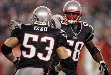 FOXBOROUGH, MA - AUGUST 17:  Pierre Woods #58 of the New England Patriots celebrates with teammate Larry Izzo #53 after Izzo made the stop against the Tennessee Titans during the first half of a pre-season game at Gillette Stadium August 17, 2007 in Foxborough, Massachusetts.  (Photo by Elsa/Getty Images)