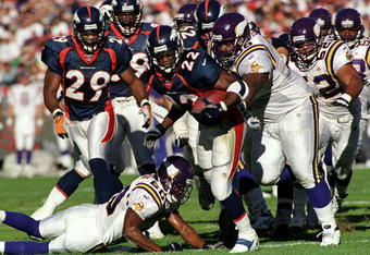 31 Oct 1999: Olandis Gary #22 of the Denver Broncos carries the ball as he is tackled during a game against the Minnesota Vikings at the Mile High Stadium in Denver, Colorado. The Vikings defeated the Broncos 23-20. Mandatory Credit: Rodolfo Ganzales  /Allsport