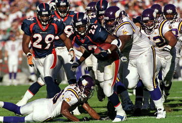 31 Oct 1999: Olandis Gary #22 of the Denver Broncos carries the ball as he is tackled during a game against the Minnesota Vikings at the Mile High Stadium in Denver, Colorado. The Vikings defeated the Broncos 23-20. Mandatory Credit: Rodolfo Ganzales  /Allsport