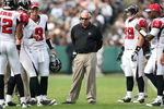 OAKLAND, CA - NOVEMBER 2:  Head Coach Mike Smith of the Atlanta Falcons stands on the field in the midst of his players wearing his radio headset during a break in the game against the Oakland Raiders on November 2, 2008 at the Oakland-Alameda County Coliseum in Oakland, California. The Falcons defeated the Raiders 24-0. (Photo by Jed Jacobsohn/Getty Images)
