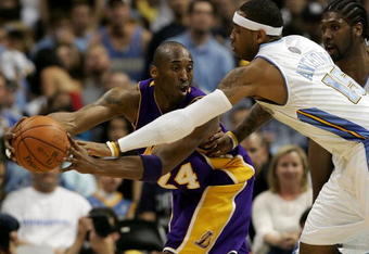 DENVER - MAY 23:  Kobe Bryant #24 of the Los Angeles Lakers looks to pass the ball around Carmelo Anthony #15 and Nene #31 of the Denver Nuggets in Game Three of the Western Conference Finals during the 2009 NBA Playoffs at Staples Center on May 23, 2009 in Denver, Colorado. NOTE TO USER: User expressly acknowledges and agrees that, by downloading and or using this photograph, User is consenting to the terms and conditions of the Getty Images License Agreement.  (Photo by Jed Jacobsohn/Getty Images)