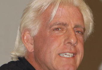 GARDEN CITY, NY - MARCH 3:  World Wrestling Entertainment (WWE) professional wrestler Ric Flair speaks on a panel during the 'Professor For A Day' event at Nassau Community College March 3, 2003 in Garden City, New York. Flair acted as an assistant professor to WWE CEO Linda McMahon, who lectured a group of sports marketing majors on the marketing and promotional strategies that have made the WWE a long-term success.  (Photo By Steven Henry/Getty Images)