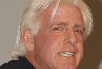 GARDEN CITY, NY - MARCH 3:  World Wrestling Entertainment (WWE) professional wrestler Ric Flair speaks on a panel during the 'Professor For A Day' event at Nassau Community College March 3, 2003 in Garden City, New York. Flair acted as an assistant professor to WWE CEO Linda McMahon, who lectured a group of sports marketing majors on the marketing and promotional strategies that have made the WWE a long-term success.  (Photo By Steven Henry/Getty Images)