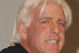 GARDEN CITY, NY - MARCH 3:  World Wrestling Entertainment (WWE) professional wrestler Ric Flair speaks on a panel during the 'Professor For A Day' event at Nassau Community College March 3, 2003 in Garden City, New York. Flair acted as an assistant professor to WWE CEO Linda McMahon, who lectured a group of sports marketing majors on the marketing and promotional strategies that have made the WWE a long-term success.  (Photo By Steven Henry/Getty Images)