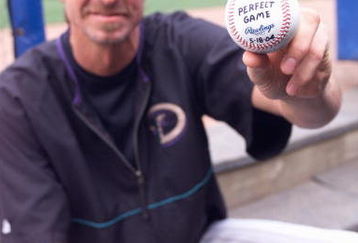 ATLANTA - MAY 19:  Randy Johnson of the Arizona Diamondbacks poses with a ball on May 19, 2004 at Turner Field in Atlanta, Georgia.  The ball is commemorating his perfect game against the Atlanta Braves on May 18.  (Photo by Scott Cunningham/Getty Images)