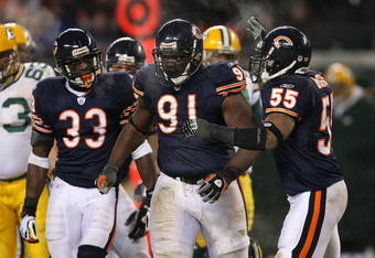 CHICAGO - DECEMBER 22: Charles Tillman #33, Tommie Harris #91 and Lance Briggs #55 of the Chicago Bears celebrate a tackle for a loss against the Green Bay Packers on December 22, 2008 at Soldier Field in Chicago, Illinois. The Bears defeated the Packers 20-17 in overtime. (Photo by Jonathan Daniel/Getty Images)
