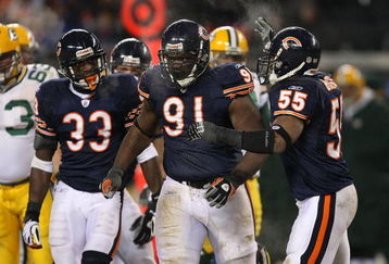 CHICAGO - DECEMBER 22: Charles Tillman #33, Tommie Harris #91 and Lance Briggs #55 of the Chicago Bears celebrate a tackle for a loss against the Green Bay Packers on December 22, 2008 at Soldier Field in Chicago, Illinois. The Bears defeated the Packers 20-17 in overtime. (Photo by Jonathan Daniel/Getty Images)