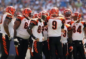 EAST RUTHERFORD, NJ - SEPTEMBER 21:  Carson Palmer #9  of the Cincinnati Bengals talks in the huddle as teammates Chad 'Ocho Cinco' Johnson #85 and T.J. Houshmandzadeh #84 listen during the first half of the game against the New York Giants on September 21, 2008 at Giants Stadium in East Rutherford, New Jersey  (Photo by Elsa/Getty Images)