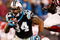CHARLOTTE, NC - JANUARY 10:  DeAngelo Williams #34 of the Carolina Panthers runs the ball while Bryan Robinson #97 of the Arizona Cardinals looks on during the NFC Divisional Playoff Game on January 10, 2009 at Bank of America Stadium in Charlotte, North Carolina.  (Photo by Streeter Lecka/Getty Images)