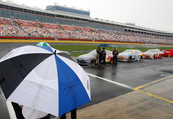 CONCORD, NC - MAY 25:  NASCAR officials stand on pit road during a rain delay for the NASCAR Sprint Cup Series Coca-Cola 600 on May 25, 2009 at Lowe's Motor Speedway in Concord, North Carolina.  (Photo by Streeter Lecka/Getty Images)