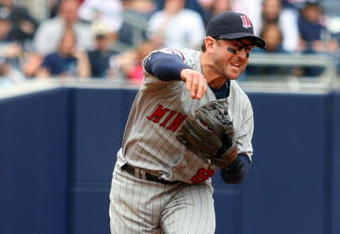 NEW YORK - MAY 17:  Nick Punto #8 of the Minnesota Twins throws against the New York Yankees on May 17, 2009 at Yankee Stadium in the Bronx borough of New York City. The Yankees defeated the Twins 3-2 in ten innings.  (Photo by Jim McIsaac/Getty Images)