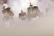 MIAMI - NOVEMBER 13:  Ramon Buchanan #45, Eric Houston #46 and Ian Symonette #68 of the Miami Hurricanes run out of the tunnel during introductions prior to taking on the Virginia Tech Hokies at Dolphin Stadium on November 13, 2008 in Miami, Florida.  (Photo by Doug Benc/Getty Images)